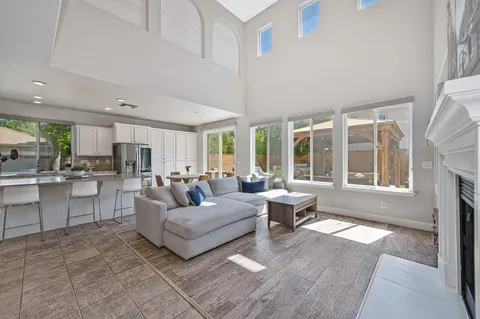 a living room with furniture and large windows