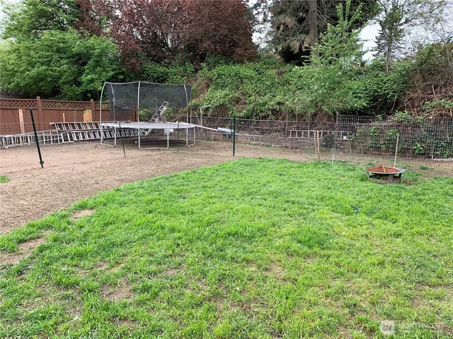 a view of backyard with seating and green space