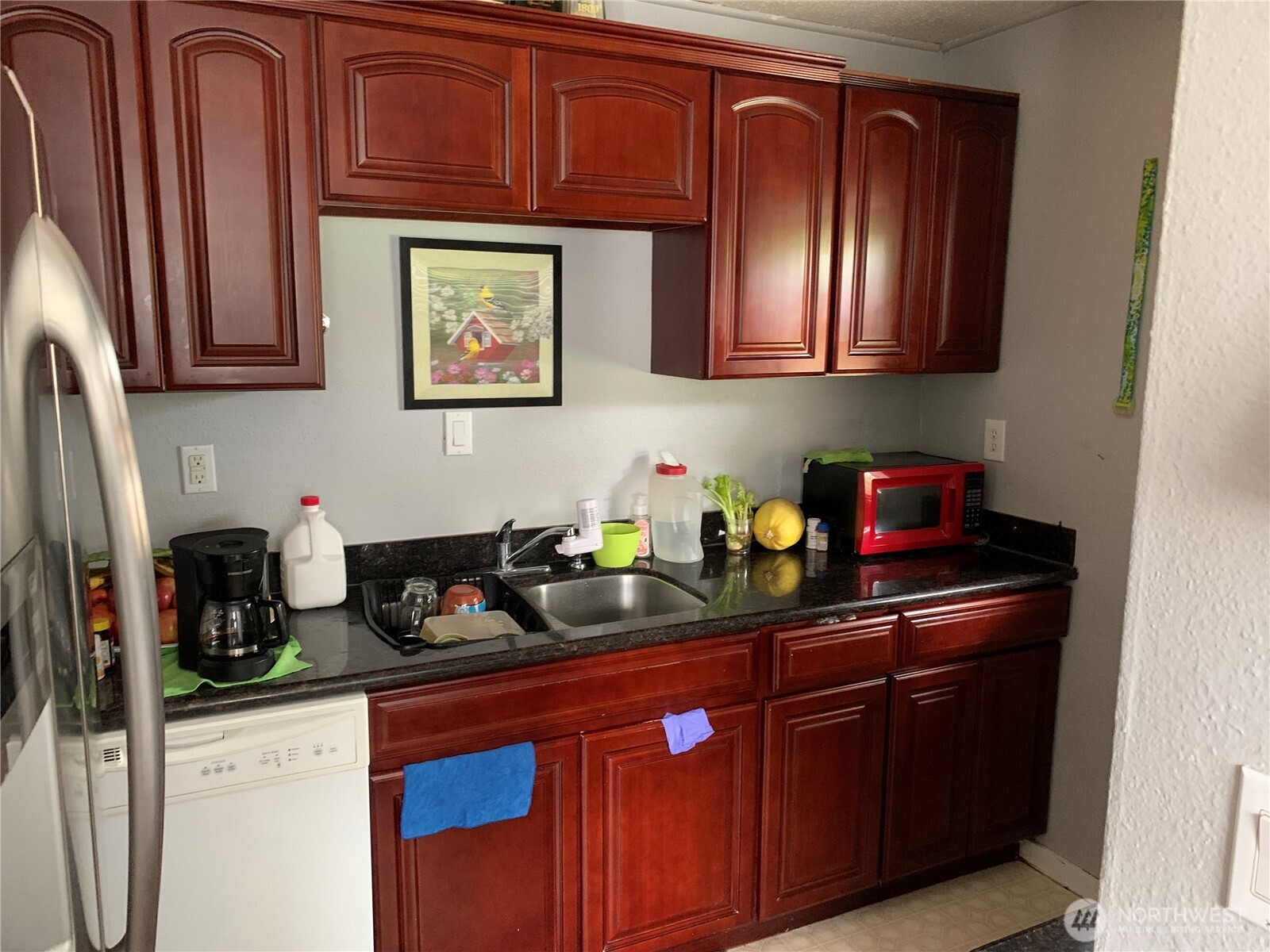 1429 Kirkland Avenue Northeast Renton, WA 98056 - Photo 7 of 19 a kitchen with stainless steel appliances granite countertop a refrigerator and wooden cabinets