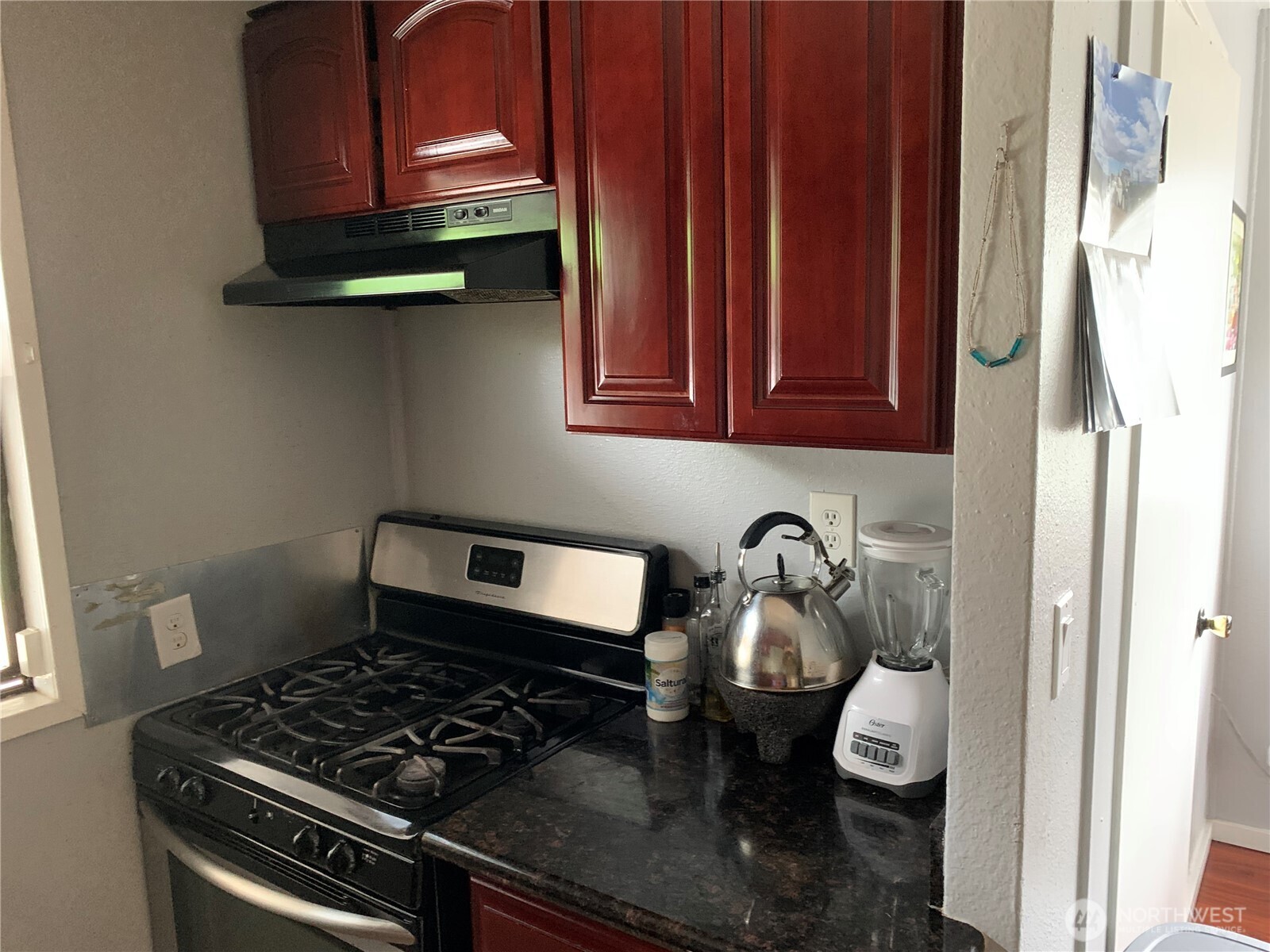 1429 Kirkland Avenue Northeast Renton, WA 98056 - Photo 8 of 19 a kitchen with wooden cabinets and a stove top oven
