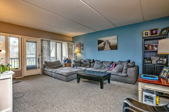 a living room with furniture and a book shelf