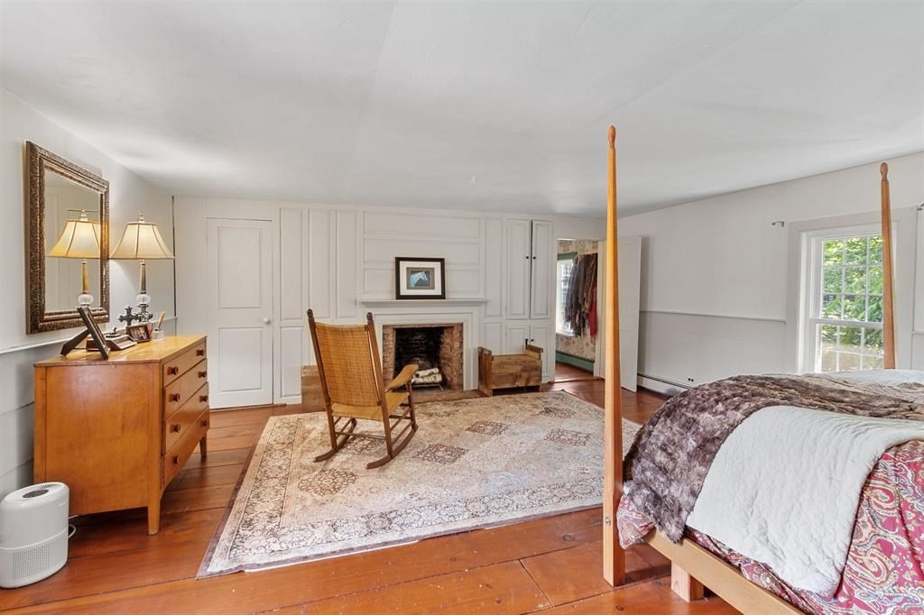 145 S Road Deerfield, NH 03037 - Photo 27 of 40 a bed room with a bed and a chair