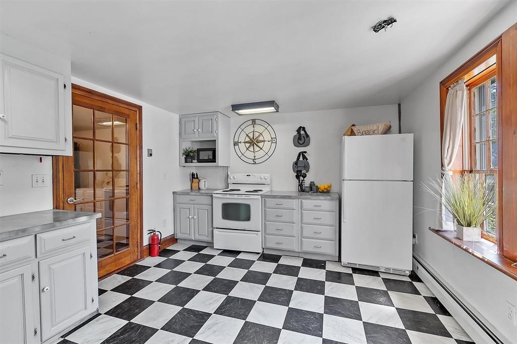 145 S Road Deerfield, NH 03037 - Photo 29 of 40 a kitchen with a stove a sink and a refrigerator