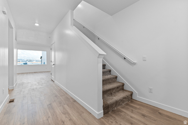 2829 North 710 West, Unit 15 Logan, UT 84321 - Photo 6 of 23 Carpeted staircase with white handrail and baseboards