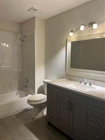 a bathroom with a double vanity sink mirror and toilet