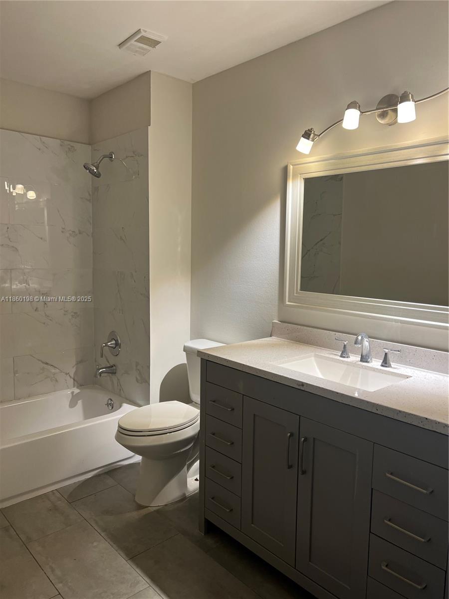 2228 Southwest 80th Terrace, Unit 2228 Miramar, FL 33025 - Photo 11 of 18 a bathroom with a double vanity sink mirror and toilet