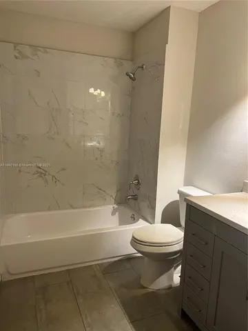 a bathroom with a toilet and a bathtub
