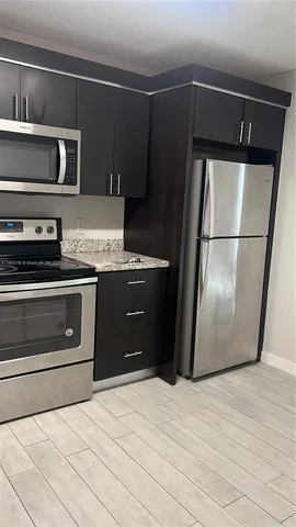 a kitchen with appliances and cabinets