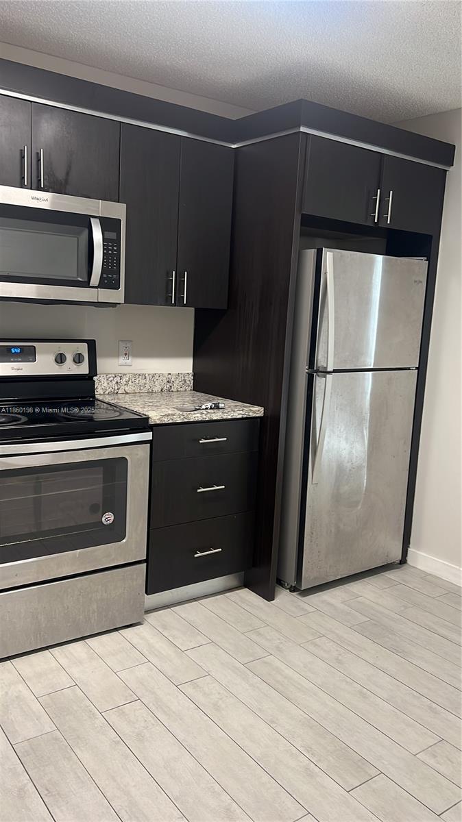 2228 Southwest 80th Terrace, Unit 2228 Miramar, FL 33025 - Photo 13 of 18 a kitchen with appliances and cabinets