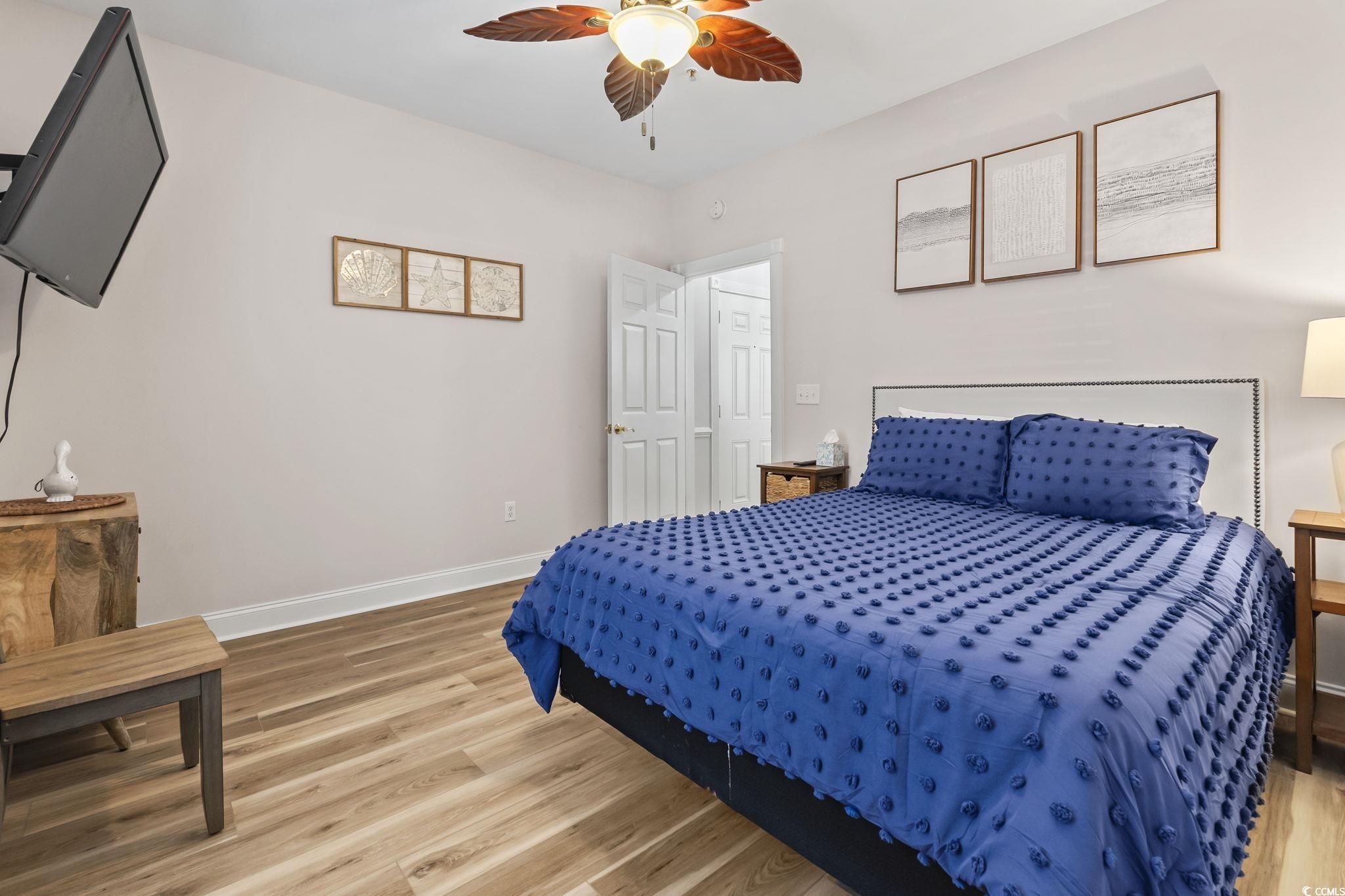 4821 Luster Leaf Circle, Unit 105 Myrtle Beach, SC 29577 - Photo 10 of 40 Bedroom with light wood finished floors and a ceiling fan