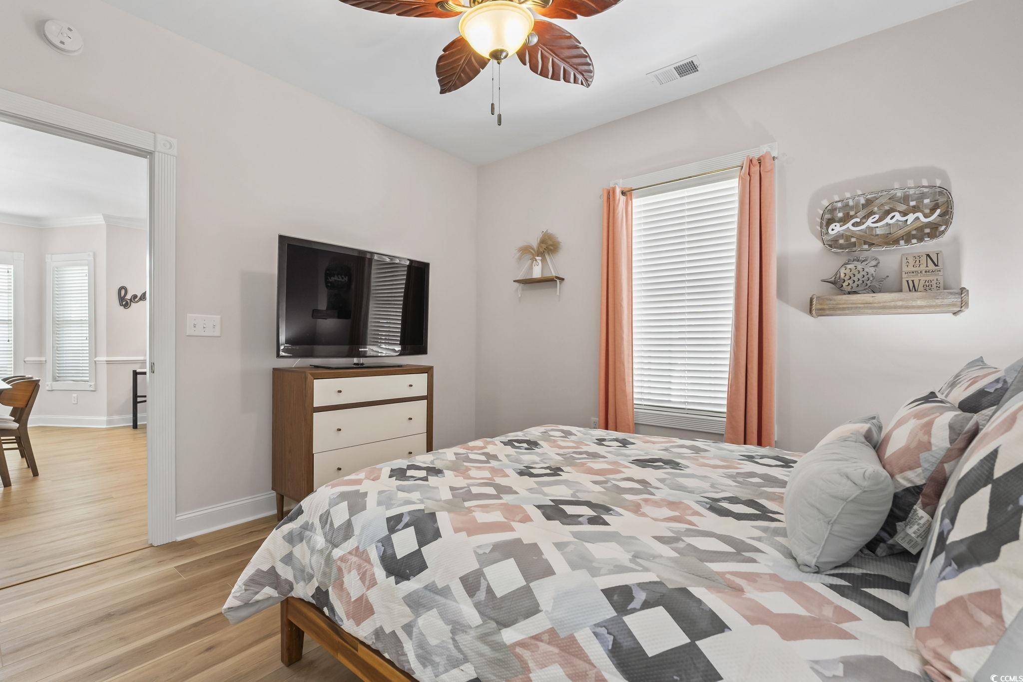4821 Luster Leaf Circle, Unit 105 Myrtle Beach, SC 29577 - Photo 17 of 40 Bedroom featuring light wood-style floors and a ceiling fan