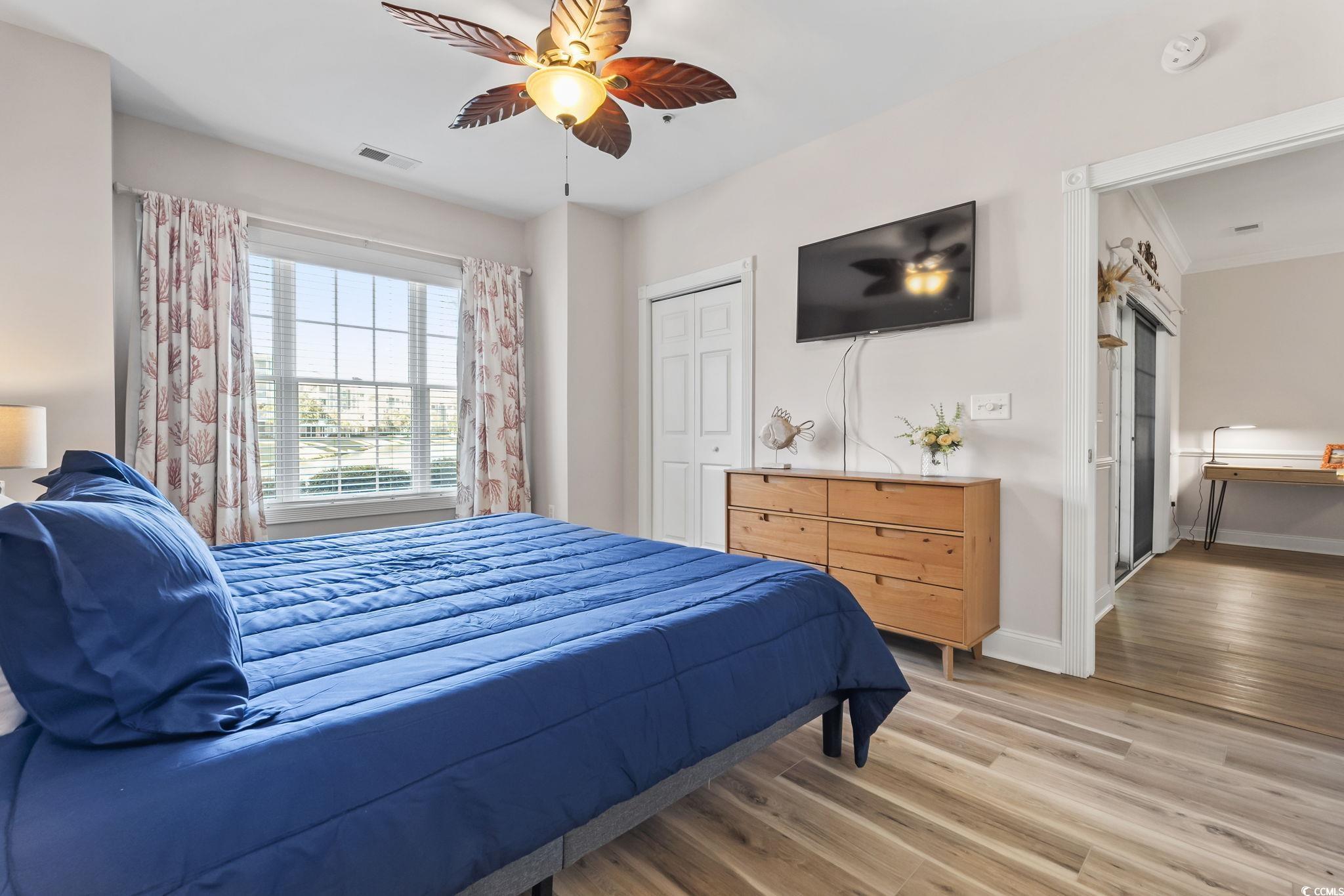 4821 Luster Leaf Circle, Unit 105 Myrtle Beach, SC 29577 - Photo 22 of 40 Bedroom featuring wood finished floors, a ceiling fan, and a closet