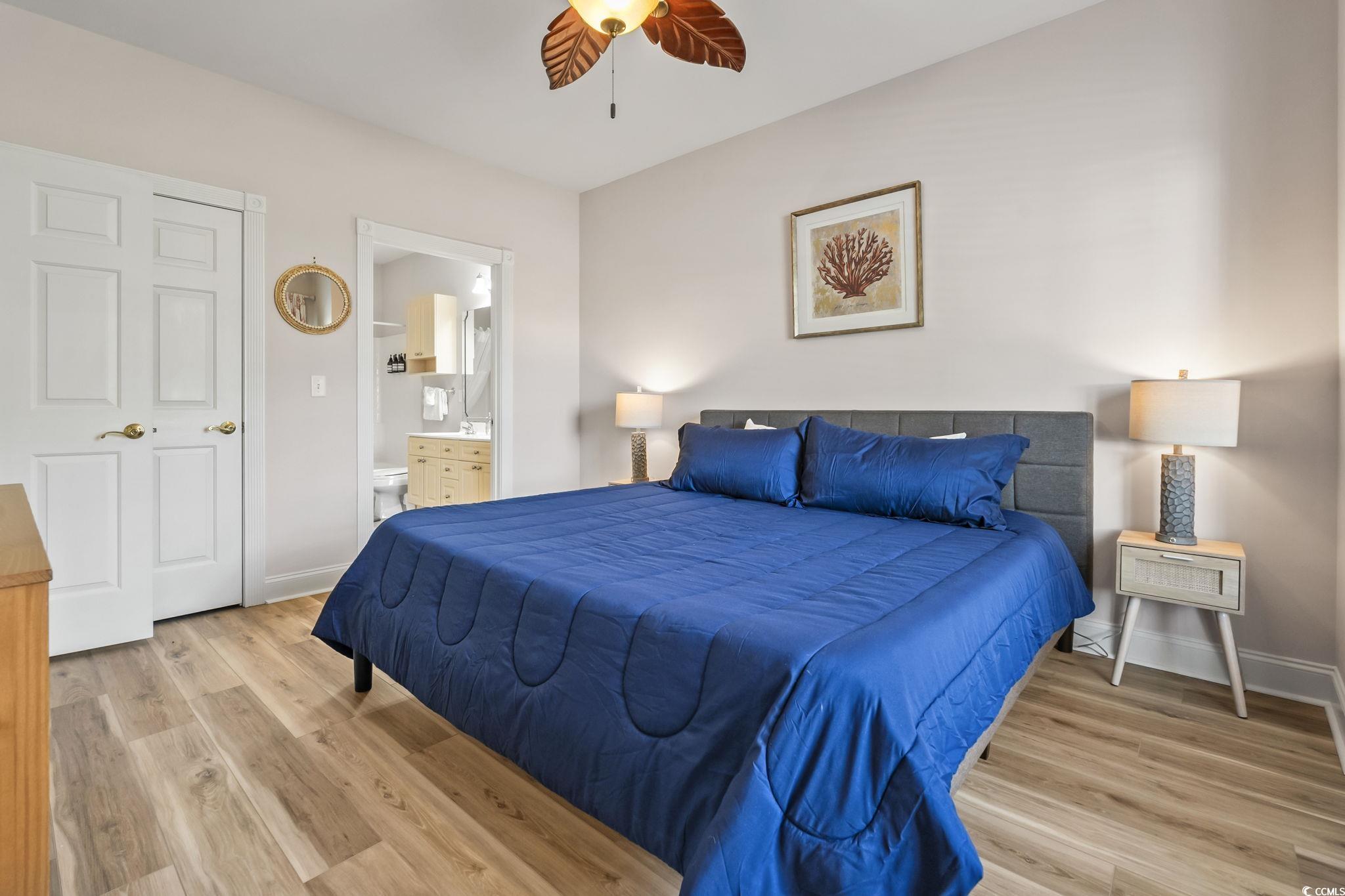 4821 Luster Leaf Circle, Unit 105 Myrtle Beach, SC 29577 - Photo 23 of 40 Bedroom featuring light wood-type flooring, ensuite bathroom, and a ceiling fan