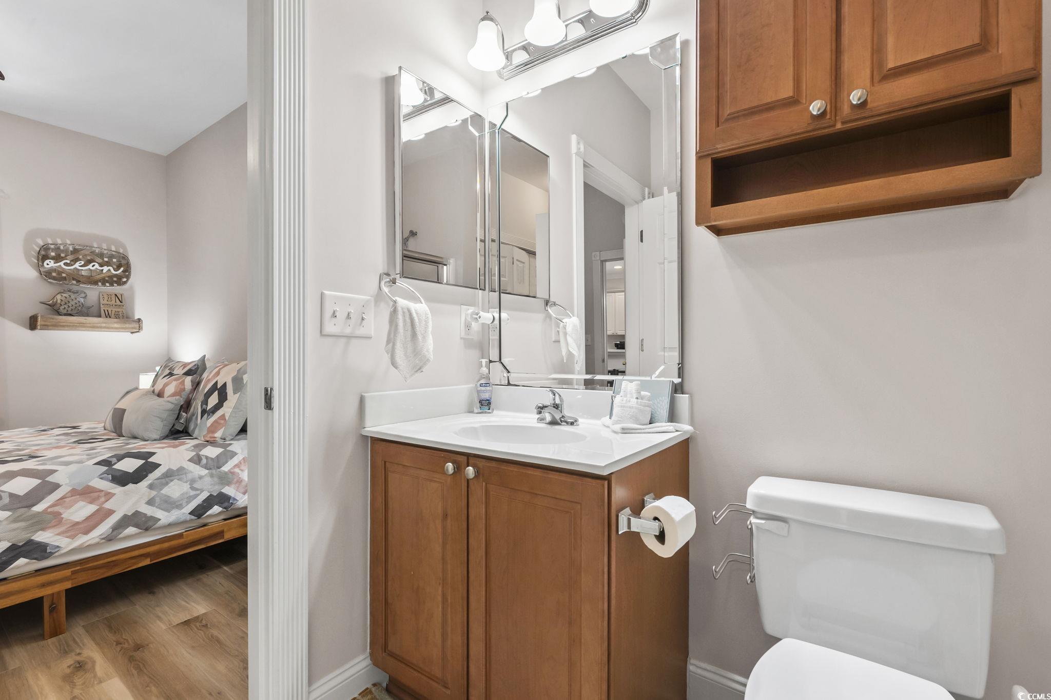 4821 Luster Leaf Circle, Unit 105 Myrtle Beach, SC 29577 - Photo 26 of 40 Bathroom featuring ensuite bath, vanity, and light wood-type flooring