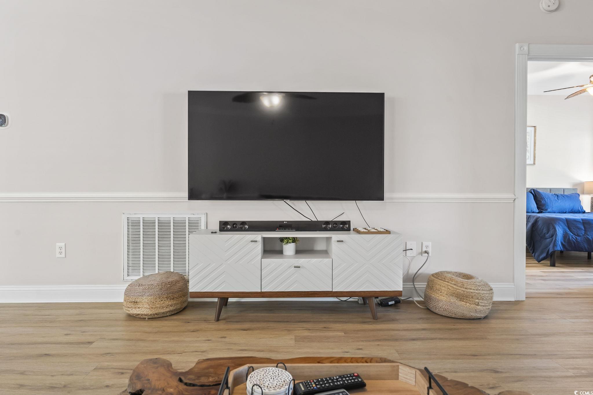 4821 Luster Leaf Circle, Unit 105 Myrtle Beach, SC 29577 - Photo 29 of 40 Living room with wood finished floors and ceiling fan