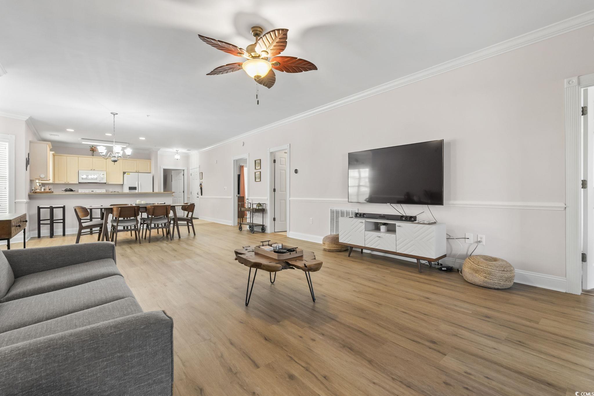 4821 Luster Leaf Circle, Unit 105 Myrtle Beach, SC 29577 - Photo 32 of 40 Living room featuring ornamental molding, light wood-type flooring, a ceiling fan, a chandelier, and recessed lighting