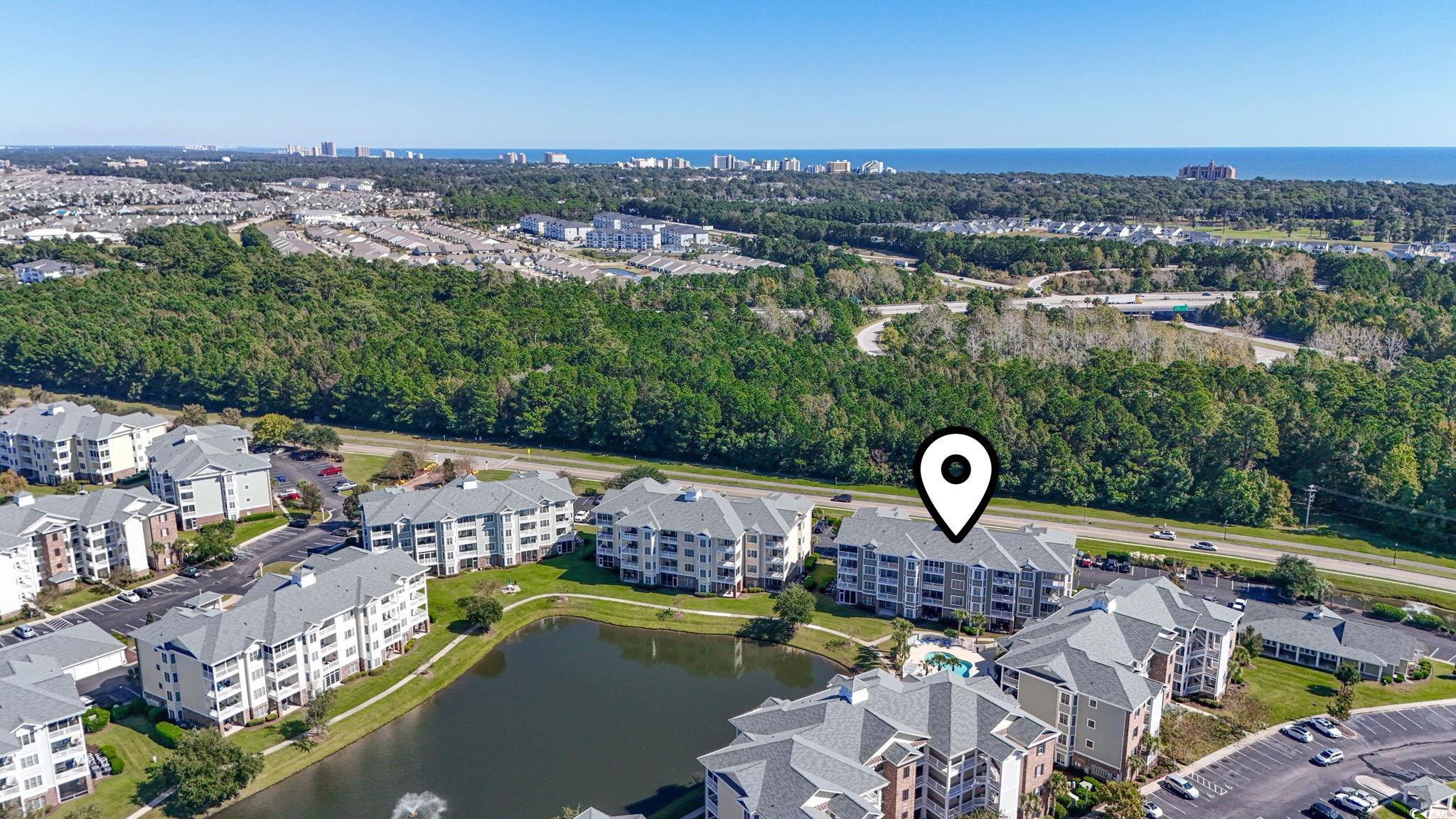 4821 Luster Leaf Circle, Unit 105 Myrtle Beach, SC 29577 - Photo 36 of 40 Aerial overview of property's location featuring a nearby body of water and a tree filled landscape
