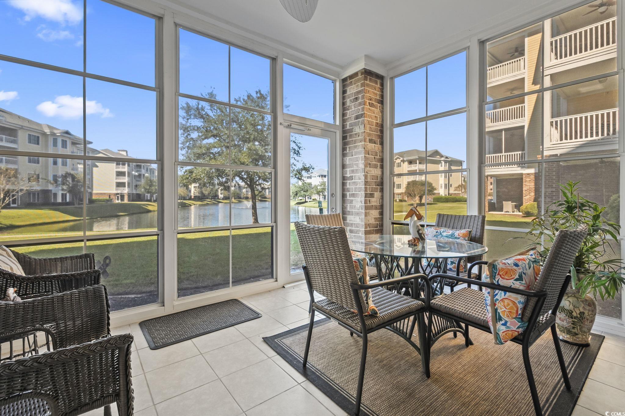 4821 Luster Leaf Circle, Unit 105 Myrtle Beach, SC 29577 - Photo 37 of 40 Sunroom featuring a water view and outdoor dining area