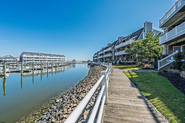 a view of swimming pool with outdoor seating and lake