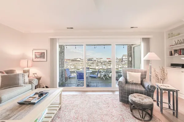 a living room with furniture a rug and a large window