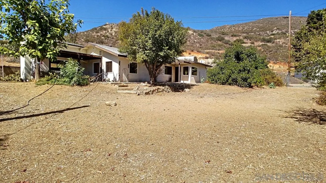 3966 Willows Road Alpine, CA 91901 - Photo 1 of 14 a view of a house with a tree in the background