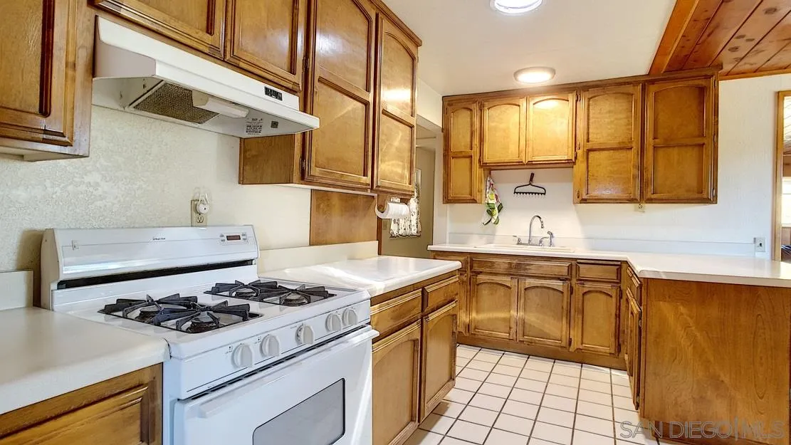 3966 Willows Road Alpine, CA 91901 - Photo 7 of 14 a kitchen with a stove a sink and a refrigerator