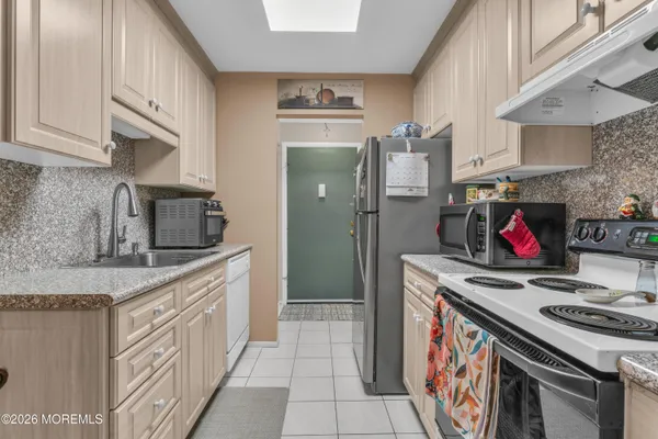 a kitchen with stainless steel appliances granite countertop a stove and a sink