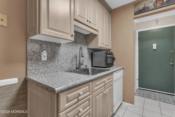 a kitchen with stainless steel appliances granite countertop a sink and cabinets