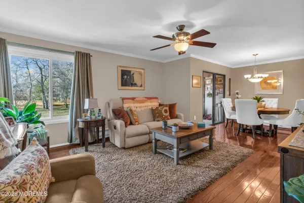 a living room with furniture a chandelier and a window