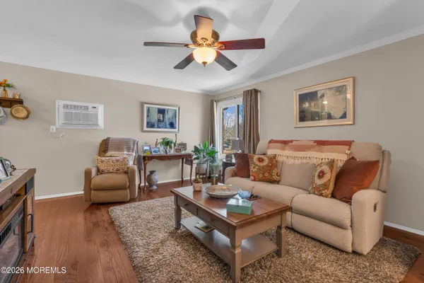 a living room with furniture and a chandelier