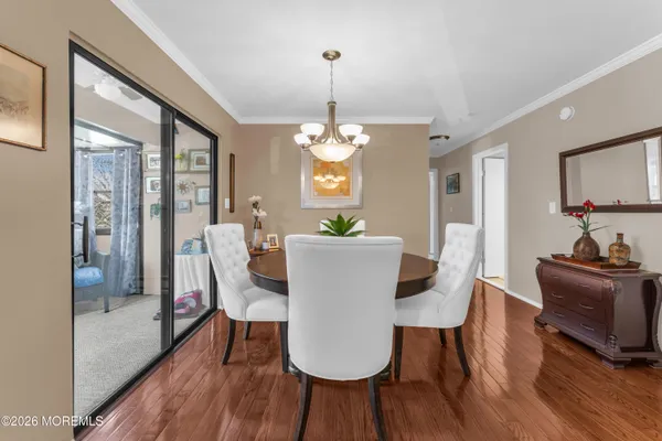 a view of a dining room with furniture window and wooden floor