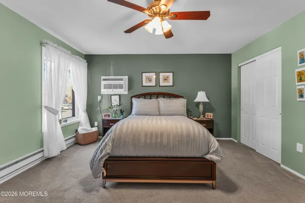 a spacious bedroom with a bed and a chandelier