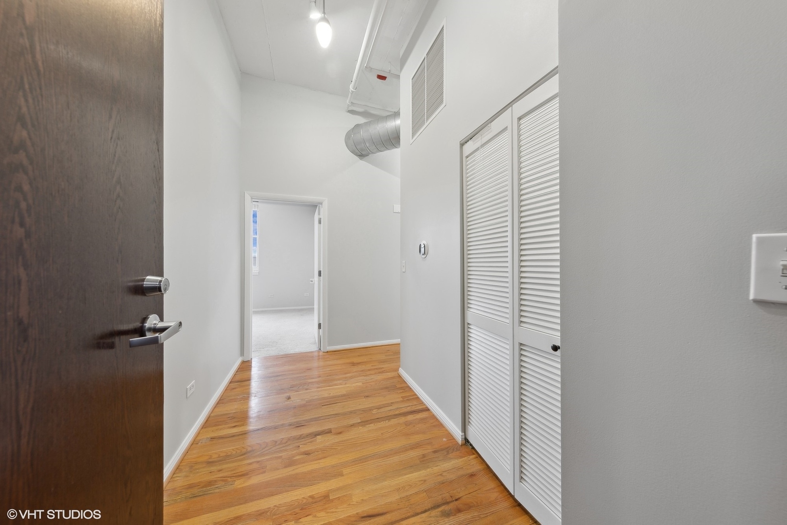 950 West Monroe Street, Unit 910 Chicago, IL 60607 - Photo 2 of 31 a view of a hallway with wooden floor and staircase