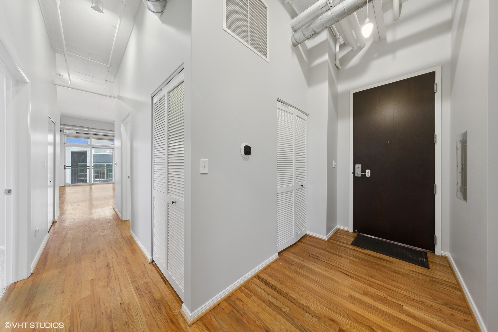 950 West Monroe Street, Unit 910 Chicago, IL 60607 - Photo 3 of 31 a view of a hallway with wooden floor and staircase