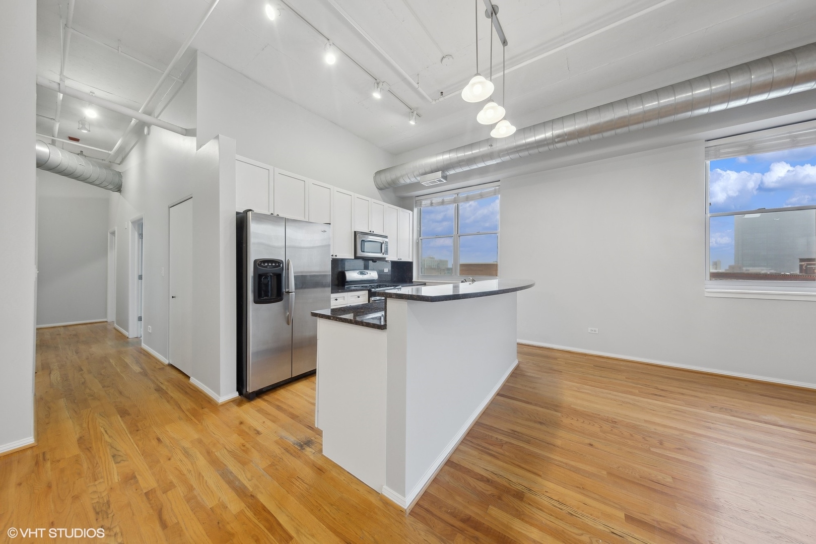 950 West Monroe Street, Unit 910 Chicago, IL 60607 - Photo 5 of 31 a view of kitchen with stainless steel appliances refrigerator stove and wooden floor