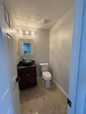 a bathroom with a sink a toilet and mirror