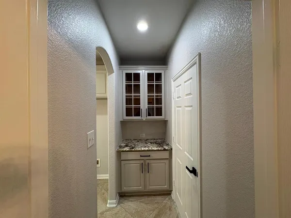 a kitchen with a refrigerator and stove top oven