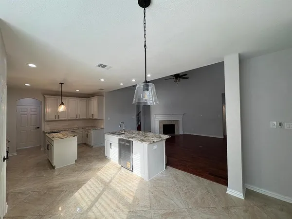 a open kitchen with a sink a stove and a refrigerator
