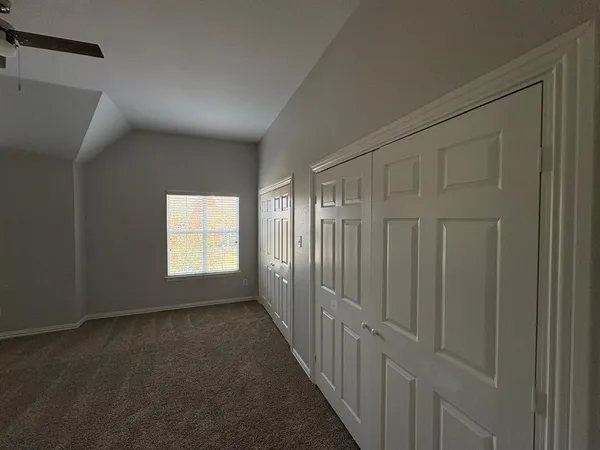 a view of a hallway with wooden floor and furniture