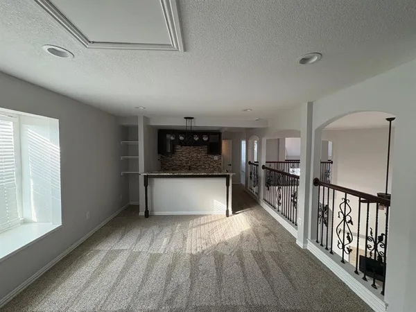 a bathroom with a granite countertop toilet sink and mirror