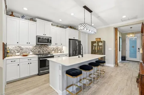 a kitchen with stainless steel appliances kitchen island granite countertop a sink and cabinets