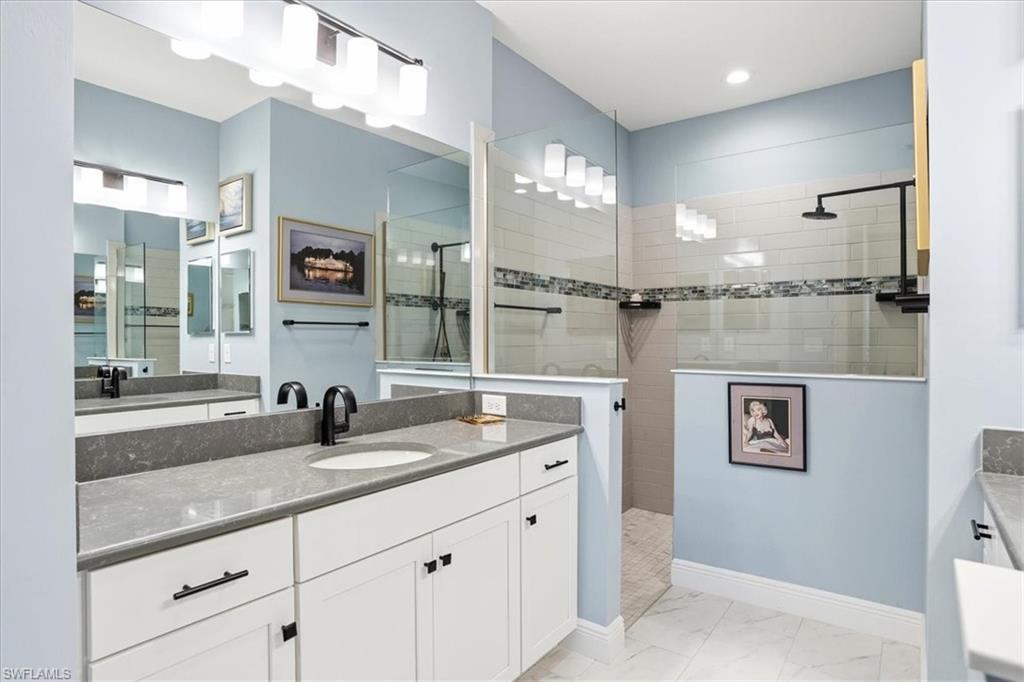 2318 Marquesa Circle Naples, FL 34112 - Photo 13 of 28 a bathroom with a sink and a mirror