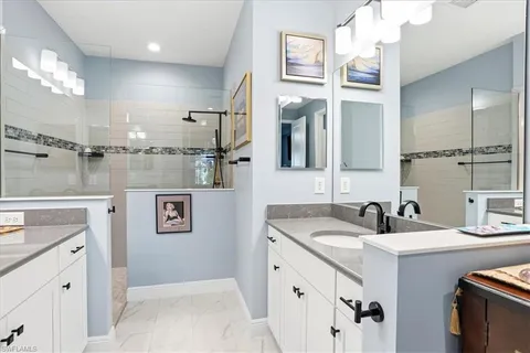 a bathroom with a sink double vanity and a mirror