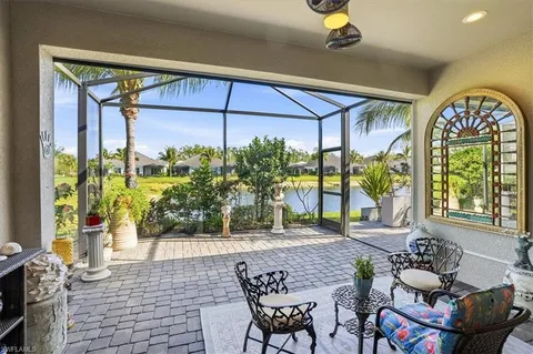 a living room with couches and a dining table with garden view