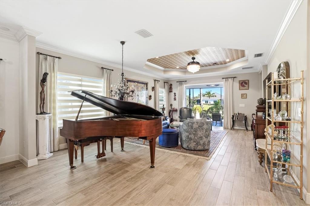 2318 Marquesa Circle Naples, FL 34112 - Photo 7 of 28 a living room with furniture and a wooden floor