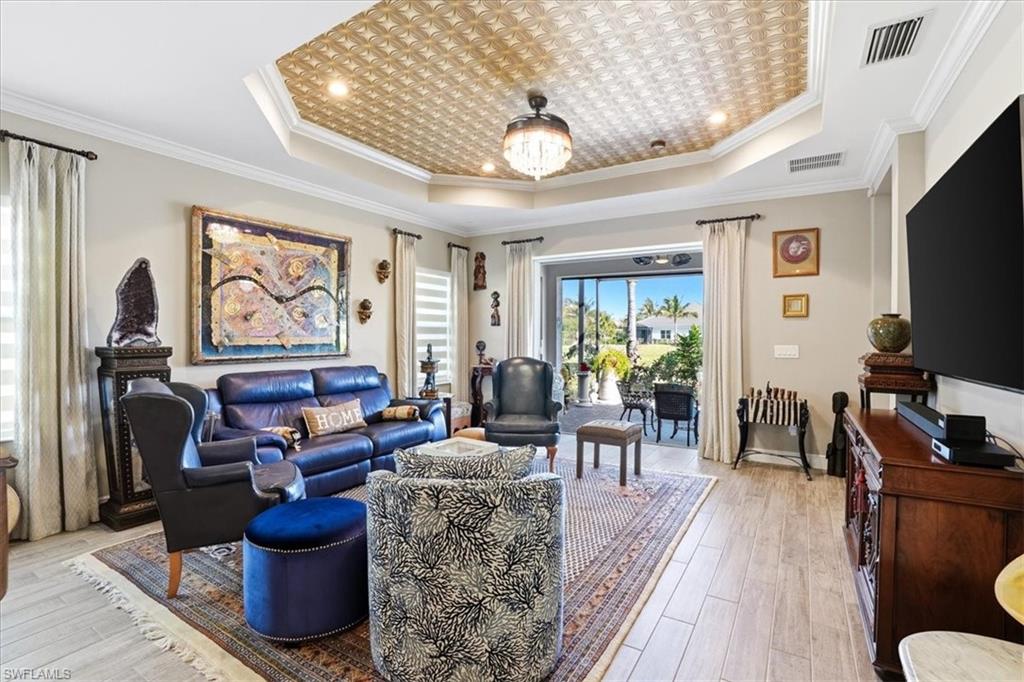2318 Marquesa Circle Naples, FL 34112 - Photo 8 of 28 a living room with furniture a large window and flat screen tv