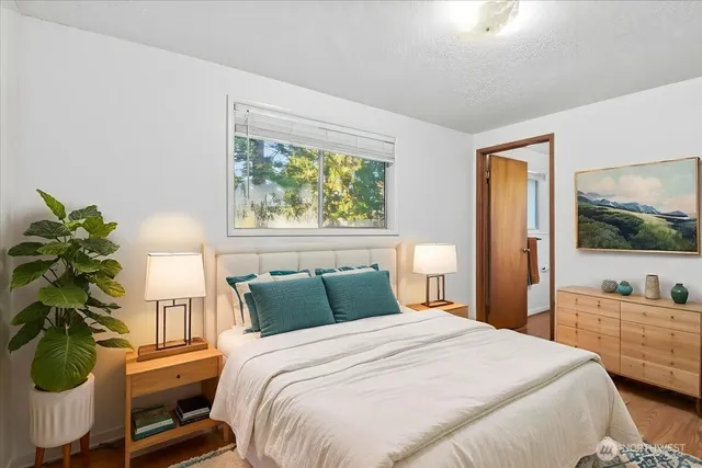 a bedroom with a bed and a large window