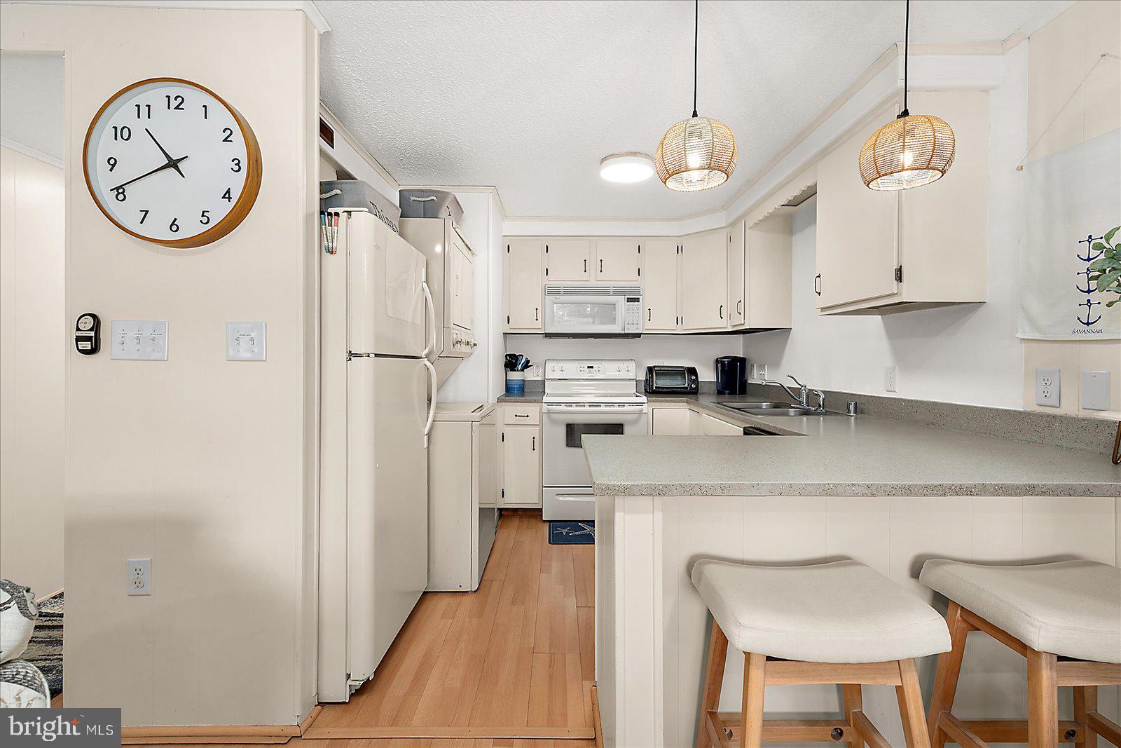 9 41st Street, Unit 320 Ocean City, MD 21842 - Photo 13 of 36 a kitchen with stainless steel appliances granite countertop a white refrigerator a sink a stove and a refrigerator