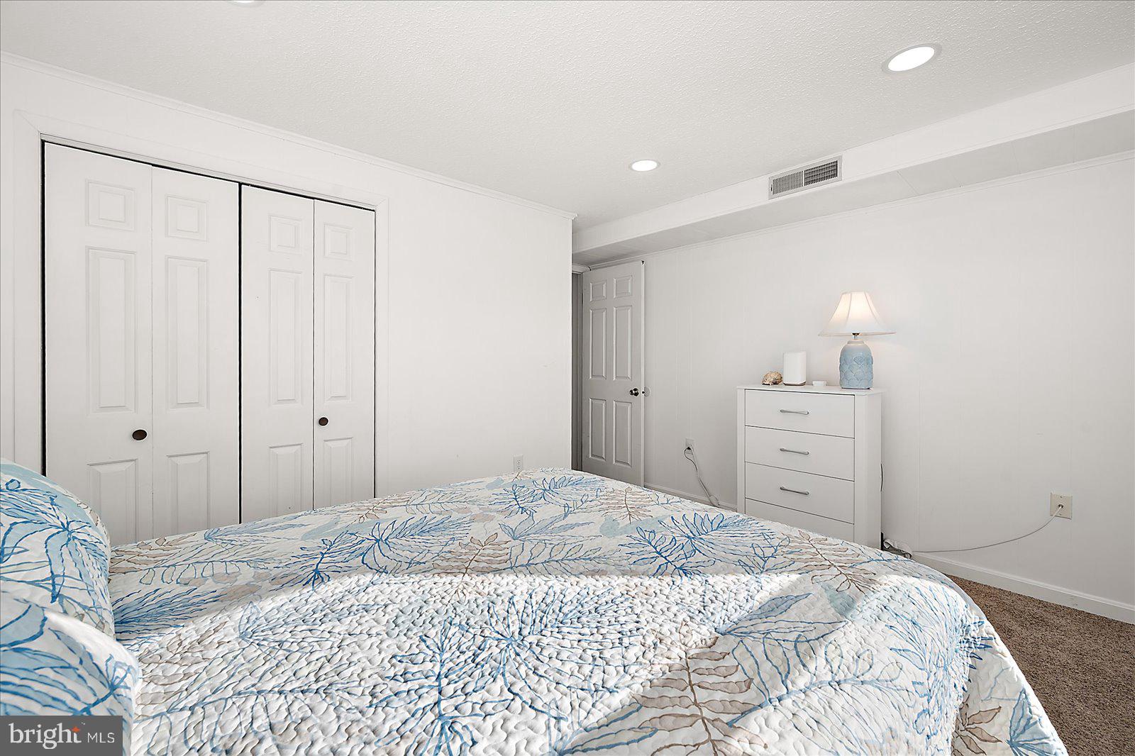 9 41st Street, Unit 320 Ocean City, MD 21842 - Photo 22 of 36 a bedroom with a bed and a walk in closet