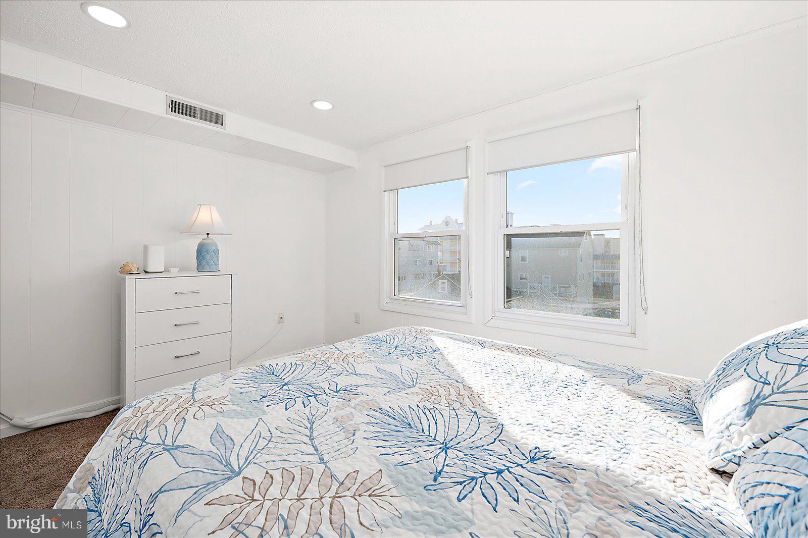 9 41st Street, Unit 320 Ocean City, MD 21842 - Photo 23 of 36 a bedroom with a bed and a window